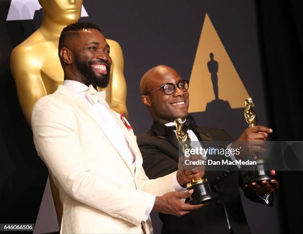 Writer/director Barry Jenkins and writer Tarell Alvin McCraney pose in the press room with the Best Adapted Screenplay award for 'Moonlight' at the...
