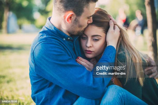 male comforts his girlfriend - sad girlfriend stock pictures, royalty-free photos & images