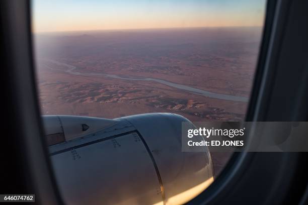 This photo taken on November 24, 2016 shows an aerial view of the Yalu river from the window of a Tupolev Tu-204 aircraft on approach to Sunan...