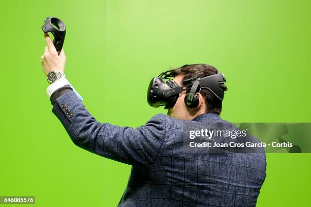 Congress attendee plays with HTC Vive during the Mobile World Congress, on February 27, 2017 in Barcelona, Spain.