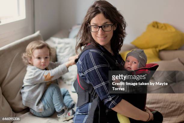 mom with baby boys at home - hot spanish women stock pictures, royalty-free photos & images