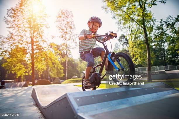 kleine jongen een fiets op de helling - crossfietsen stockfoto's en -beelden