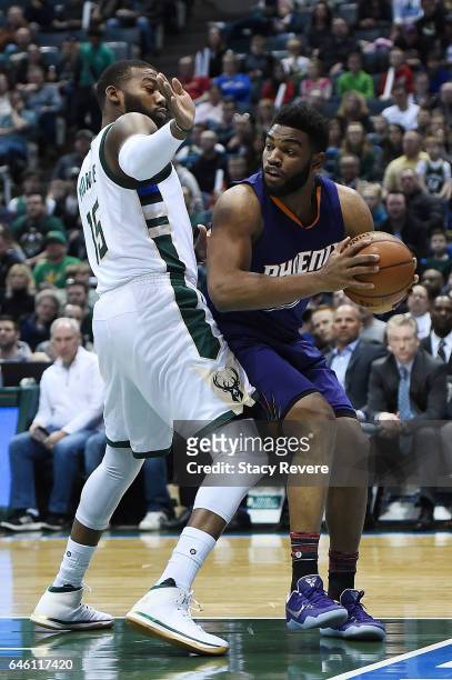 Alan Williams of the Phoenix Suns is defended by Greg Monroe of the Milwaukee Bucks during a game at the BMO Harris Bradley Center on February 26,...