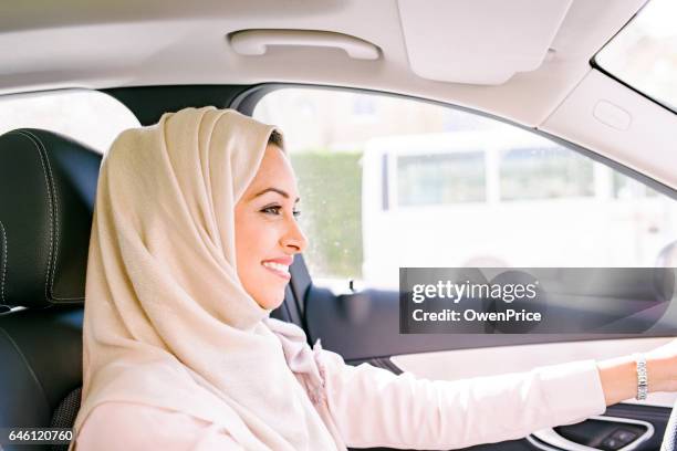 confident arabic woman driving - arab woman driving stock pictures, royalty-free photos & images