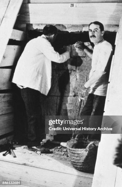 Howard Carter opening KV62, the tomb of the young pharaoh Tutankhamen in the Valley of the Kings, now renowned for the wealth of valuable antiquities...