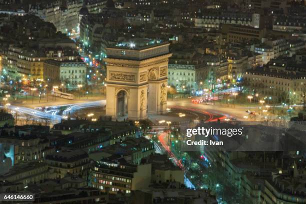 aero view of arc de triomphe at with car trace at night, paris, france - starry vault stock pictures, royalty-free photos & images