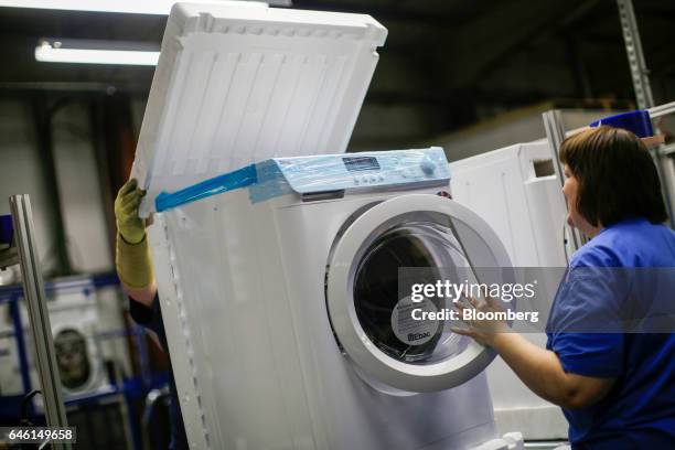 Employees assemble a washing machine on the production line at the Ebac Ltd. Factory in Newton Aycliffe, U.K., on Monday, Jan. 9, 2017. The pound has...