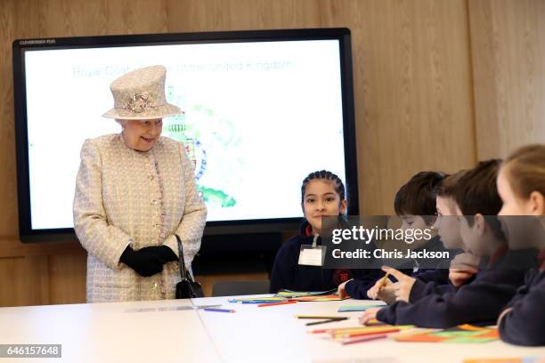 Queen Elizabeth II talks with local school children as she opens a new development at The Charterhouse at Charterhouse Square on February 28, 2017 in...