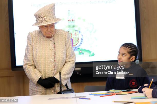 Queen Elizabeth II talks with a local school child as she and Prince Philip, Duke of Edinburgh open a new development at The Charterhouse at...