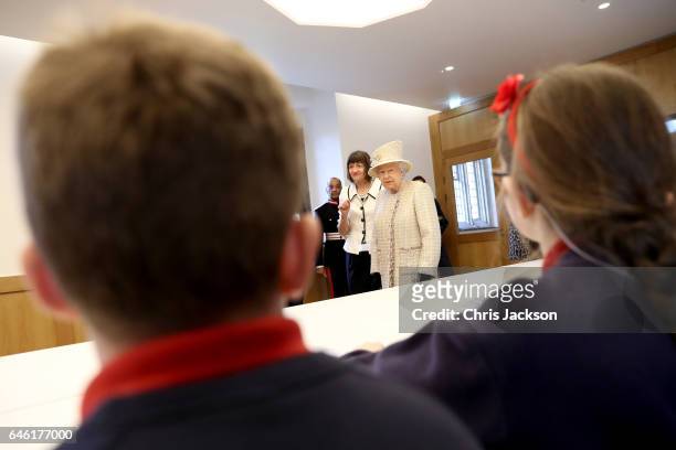 Queen Elizabeth II talks with local school children as she and Prince Philip, Duke of Edinburgh open a new development at The Charterhouse at...