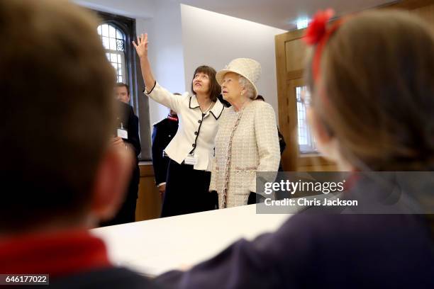 Queen Elizabeth II talks with local school children as she and Prince Philip, Duke of Edinburgh open a new development at The Charterhouse at...