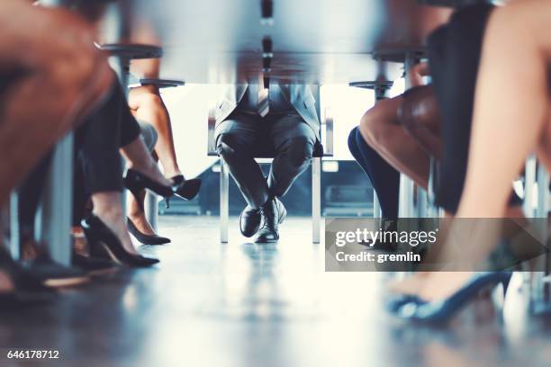 under the table shot at business meeting - legs on the table stock pictures, royalty-free photos & images