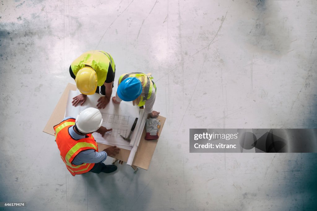 Architects looking at blueprints