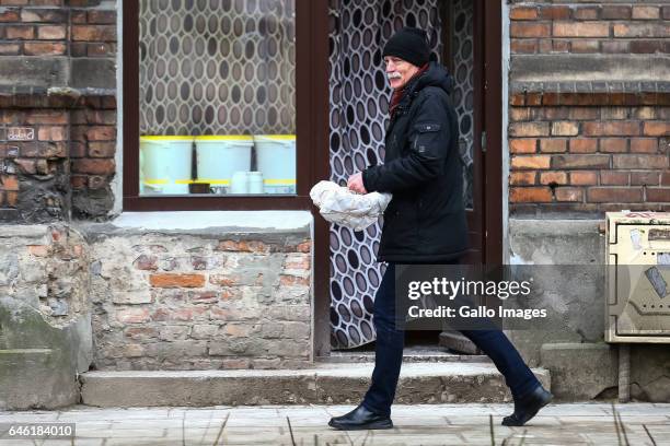 Man with a pack of donuts seen during Fat Thursday on February, 23 in Warsaw, Poland. Fat Thursday is a traditional Catholic Christian feast...
