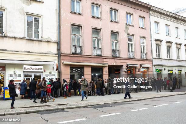 People standing in line in front of a bakery during Fat Thursday on February, 23 in Warsaw, Poland. Fat Thursday is a traditional Catholic Christian...