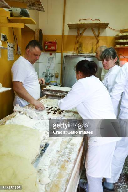 People producing donuts during Fat Thursday on February, 23 in Warsaw, Poland. Fat Thursday is a traditional Catholic Christian feast associated with...