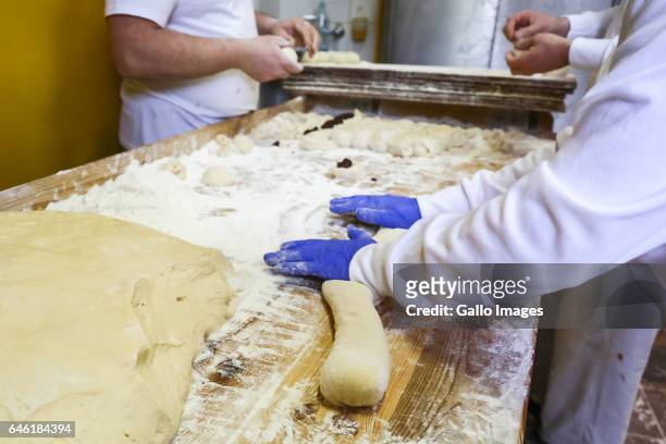 Man kneading donuts cake during Fat Thursday on February, 23 in Warsaw, Poland. Fat Thursday is a traditional Catholic Christian feast associated...