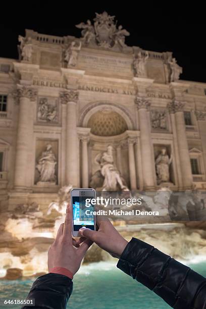 young woman photographing the trevi fountain - hands fountain water stock-fotos und bilder