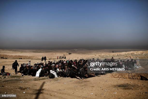 Displaced Iraqis are seen gathered as they flee the city of Mosul while Iraqi forces battle against Islamic State group jihadists to recapture the...