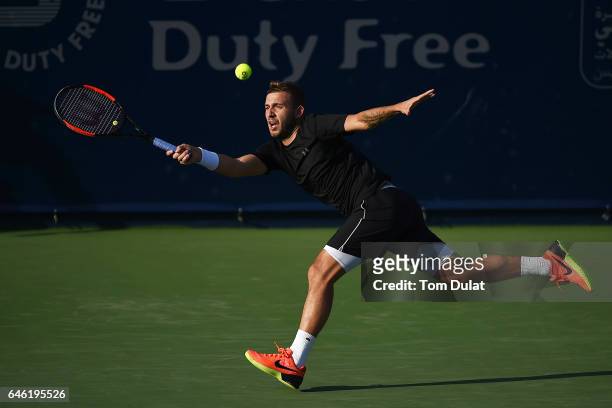 Daniel Evans of United Kingdom returns a shot during his match against Dustin Brown of Germany on day three of the ATP Dubai Duty Free Tennis...