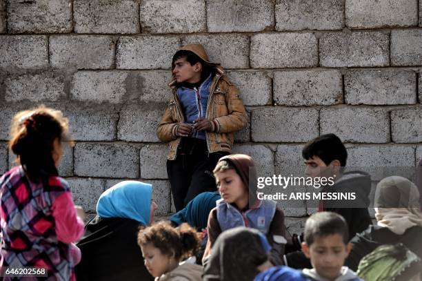 Displaced Iraqis are seen gathered as they flee the city of Mosul while Iraqi forces battle against Islamic State group jihadists to recapture the...