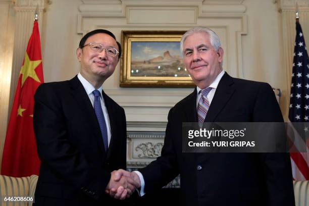 Secretary of State Rex Tillerson shakes hands with Chinese State Councilor Yang Jiechi before their meeting at the State Department in Washington,DC...