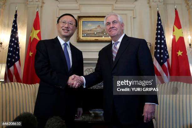 Secretary of State Rex Tillerson shakes hands with Chinese State Councilor Yang Jiechi before their meeting at the State Department in Washington,DC...