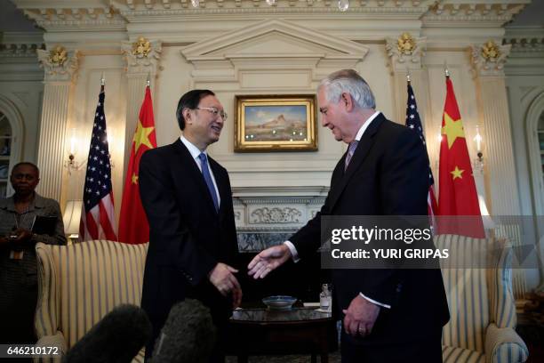 Secretary of State Rex Tillerson greets Chinese State Councilor Yang Jiechi during their meeting at the State Department in Washington,DC on February...