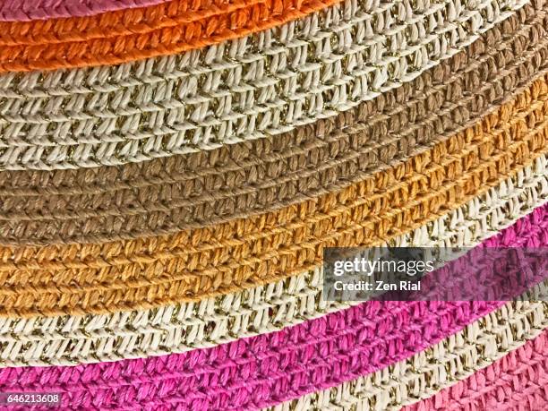 close-up of a multi colored brim of a straw hat shows curves of the woven material - cucitura foto e immagini stock