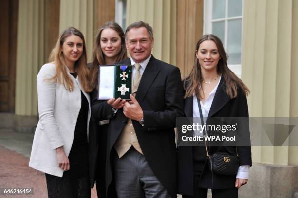 Adventurer Sir David Hempleman-Adams at Buckingham Palace in central London with his daughters Alicia, Amelia and Camilla, after he was made a Knight...