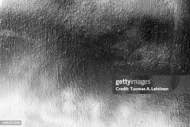 close-up of a uneven wall painted with spray paints in black&white. - spray paint stock pictures, royalty-free photos & images