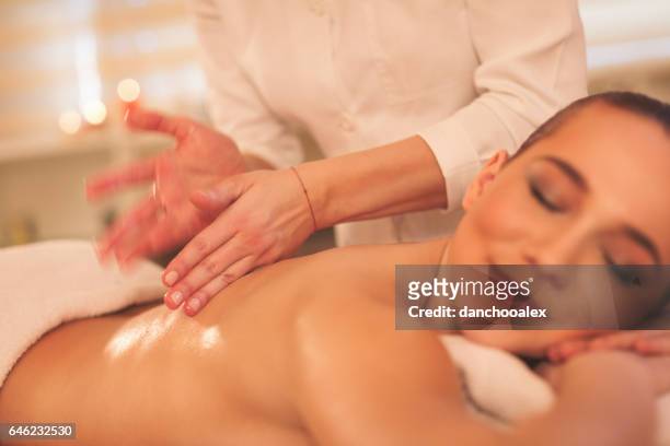 massage process - woman lying on stomach with feet up stock pictures, royalty-free photos & images