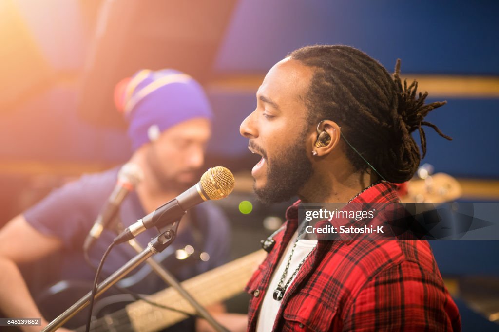 Music band rehearsing in studio