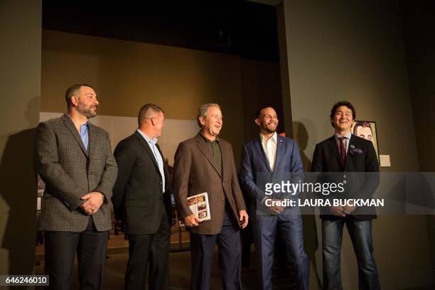 Former US President George W. Bush greets US military veterans at a press preview of his new painting exhibit, "Portraits of Courage", at the George...