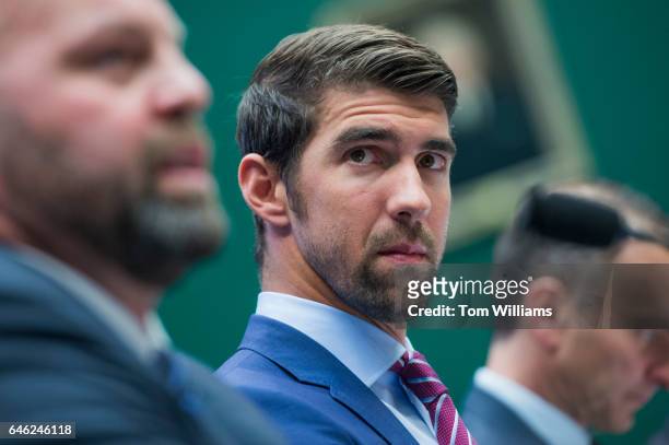 From left, Olympic gold medalists Adam Nelson and Michael Phelps, and Travis Tygart, CEO of the U.S. Anti-Doping Agency, appear before a House Energy...