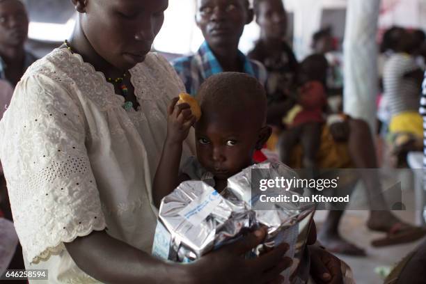 Young girl is given food supplements at a World Food Programme, nutritional screening at a community health centre at a refugee settlement on...