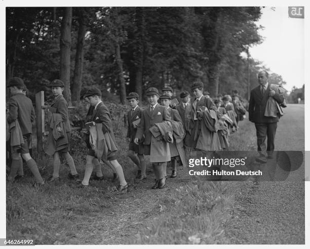 The young Prince Charles, the Prince of Wales, walks back to school from church with a group of his schoolfellows. | Location: Headly, Berkshire,...
