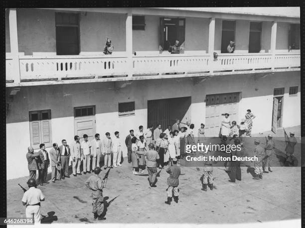Suspected communist sympathizers are lined up for questioning at an interrogation centre, in San Juan, Puerto Rico, following a Nationalist uprising.