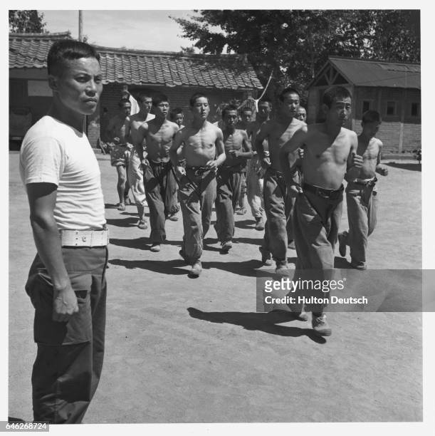 North Korean Prisoners Taking Exercise Whilst Interned At Taegu POW Camp. With the United Nations forces going over to the offensive in Korea,...