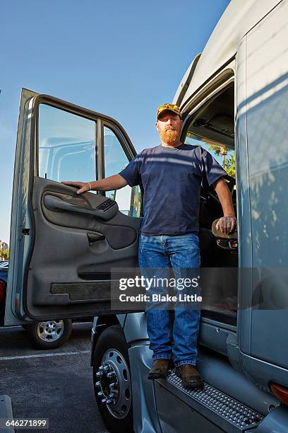 trucker standing in cab doorway - seghet bildbanksfoton och bilder