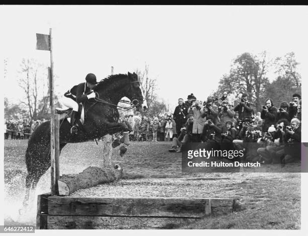 Riding her second horse "Goodwill," Princess Anne comes out of a water obstacle in front of a group of photographers during the Badminton Horse...