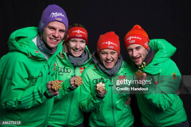 In this handout supplied by NordicFocus, Andreas Wellinger, Svenja Wuerth, Carina Vogt and Markus Eisenbichler of Germany pose with their gold medals...