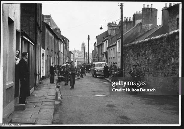 Soldiers of the Royal Warwick regiment patrol a street in Enniskillen. They are guarding a nearby radar station.
