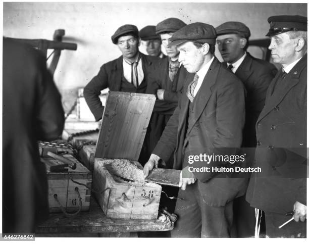 British customs officials inspect cases containing 500,000 pounds sterling worth of gold brought in from Soviet Russia.