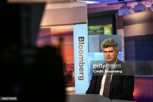 Dominic Konstam, managing director of Deutsche Bank Securities Inc., listens during a Bloomberg Television interview in New York, U.S., on Tuesday,...