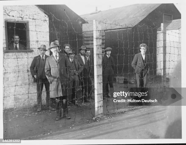 Inspection of Royal Irish Constabulary by Sir Hamar Greenwood - Sinn Feiners behind wires.