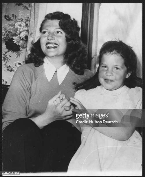 American dancer and actress Rita Hayworth holidaying with her daughter Rebecca in Gstaad, Switzerland, 1950. Rebecca is the daughter of Orson Welles.