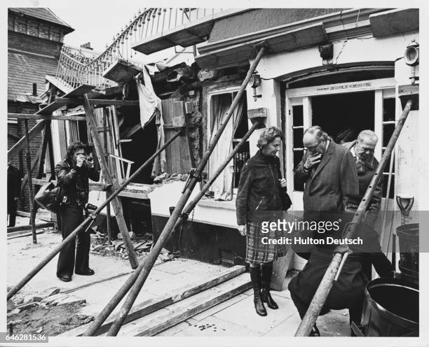 Home Secretary Roy Jenkins and Commander Huntley of the Soctland Yard bomb squad inspect the site of the Horse and Groom pub in Guildford, which was...