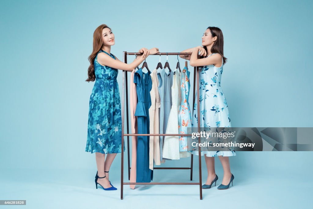 Sisters in the clothing store to buy clothes