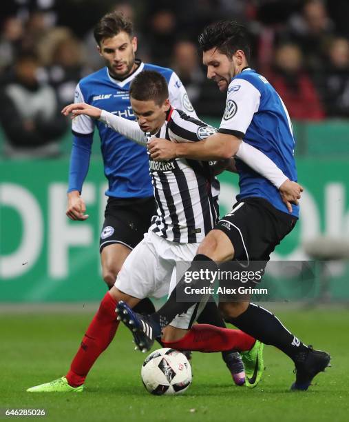 Mijat Gacinovic Of Frankfurt Is challenged by Christopher Noethe and Stephan Salger of Bielefeldduring the DFB Cup quarter final between Eintracht...